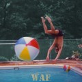 Marty flipping off a beach ball while diving into a Palos Park swimming pool