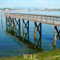 a Puget Sound pier and lonely boat on the water (Washington state)