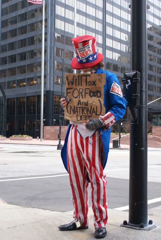 Uncle Sam at Chicago's Sears (Willis) Tower with a sign asking for National Debt money