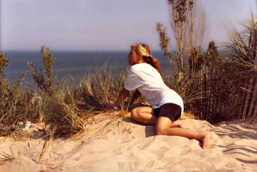 Lori looking out to the water (in Michigan, on the beach at Lake Michigan)