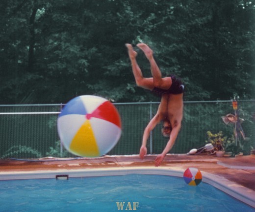 Marty flipping off a beach ball while diving into a Palos Park swimming pool